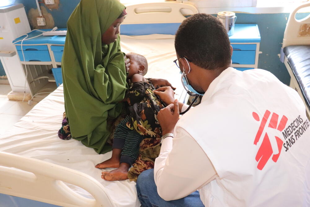 Doctor Ahmed Ilyas examining a baby at an MSF-supported hospital in Baidoa, Somalia