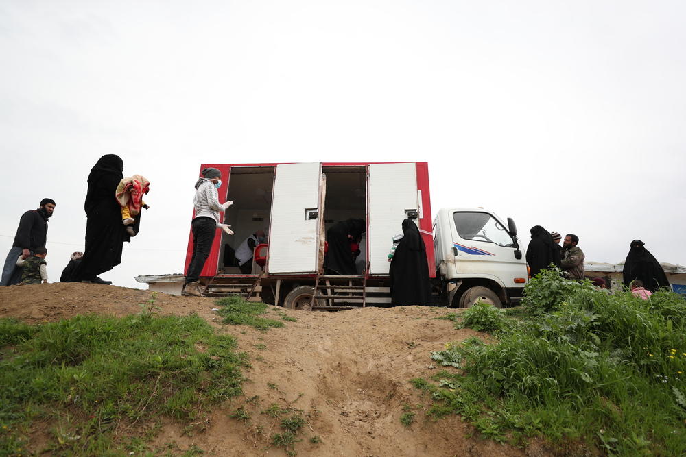 People observe social distancing measures while waiting for a consultation at MSF’s mobile clinic in a camp for internally displaced people in northwest Syria.
