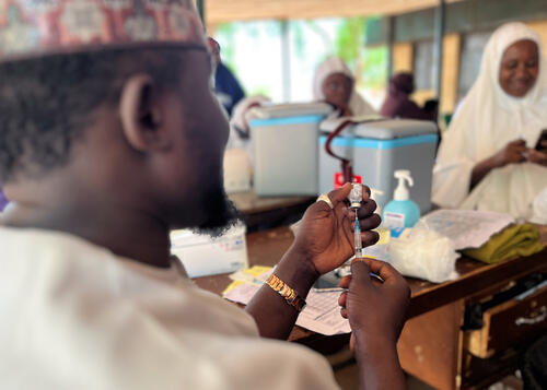 Photo of a medic preparing a vaccine Photo of a medic preparing a vaccine