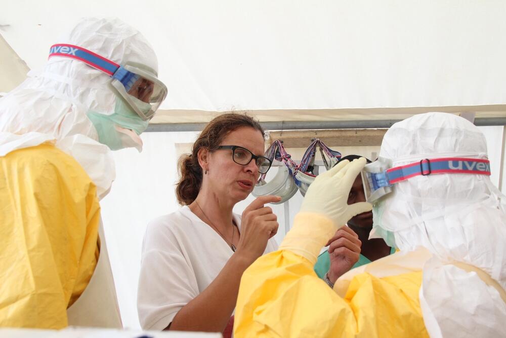 Anja Wolz helping the team with Ebola PPE during the 2014-2016 outbreak