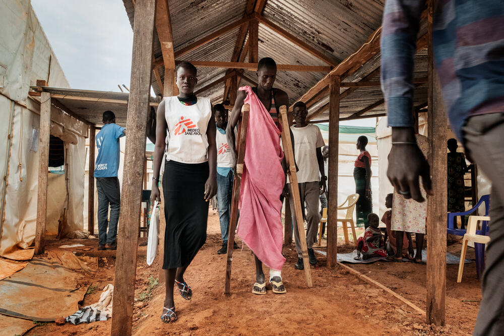 Patients and staff rush through the corridors in the MSF hospital in Bentiu. The hospital offers up to 170 beds, a modern operating theatre, outreach malaria teams with rapid testing and treatment points, among many other activities.