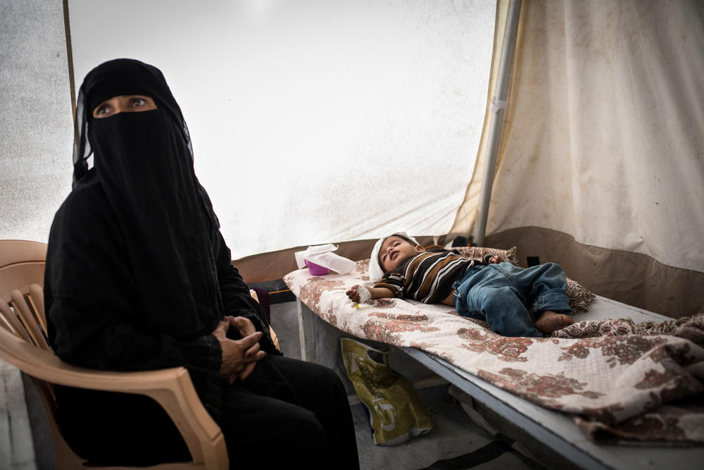 A mother watches over her sick child at the MSF cholera treatment centre in Ibb Governorate.