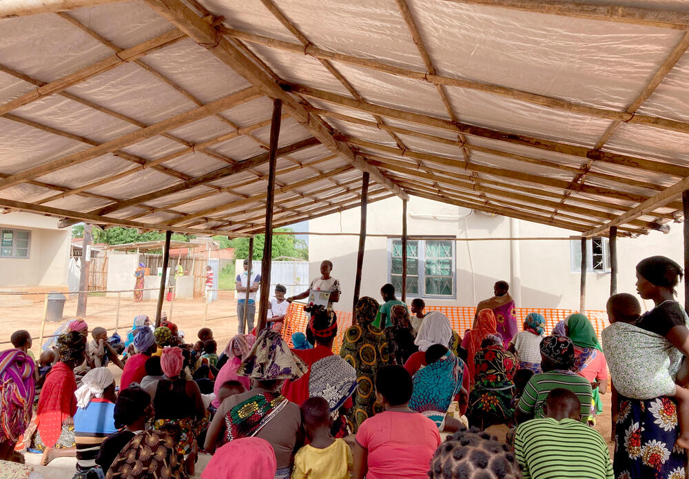 A team of MSF health promoters talk to people at a clinic in Nanga
