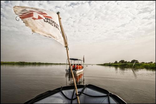 Malakal, South Sudan, March 2015. MSF staff on it s way to a MSF mobile clinic which is located at the river shore. Next to their work in the Poc ( Proteciion of civilians) inside the Un base in Malakal MSf tries to bring medical help to people that are hard to reach. After a thirty minutes boat ride the clinic can be reached where MSf provides medical helth care for TB and Kala Alzar