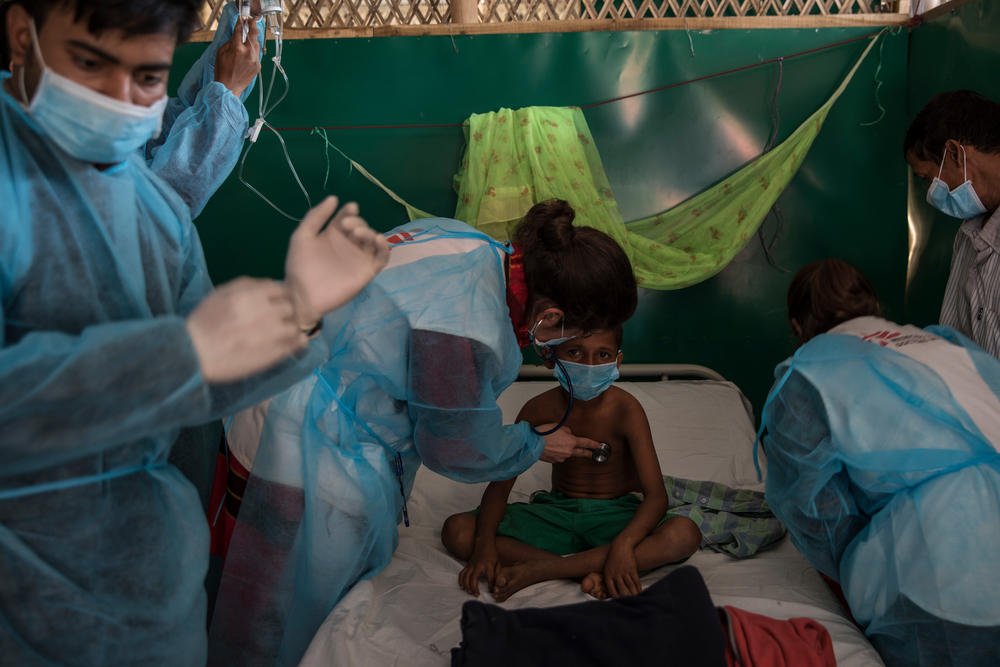 Ismail, aged 11, is given diphtheria anti-toxin by MSF doctors Beatriz and Mariela in a treatment centre in Moynarghona.