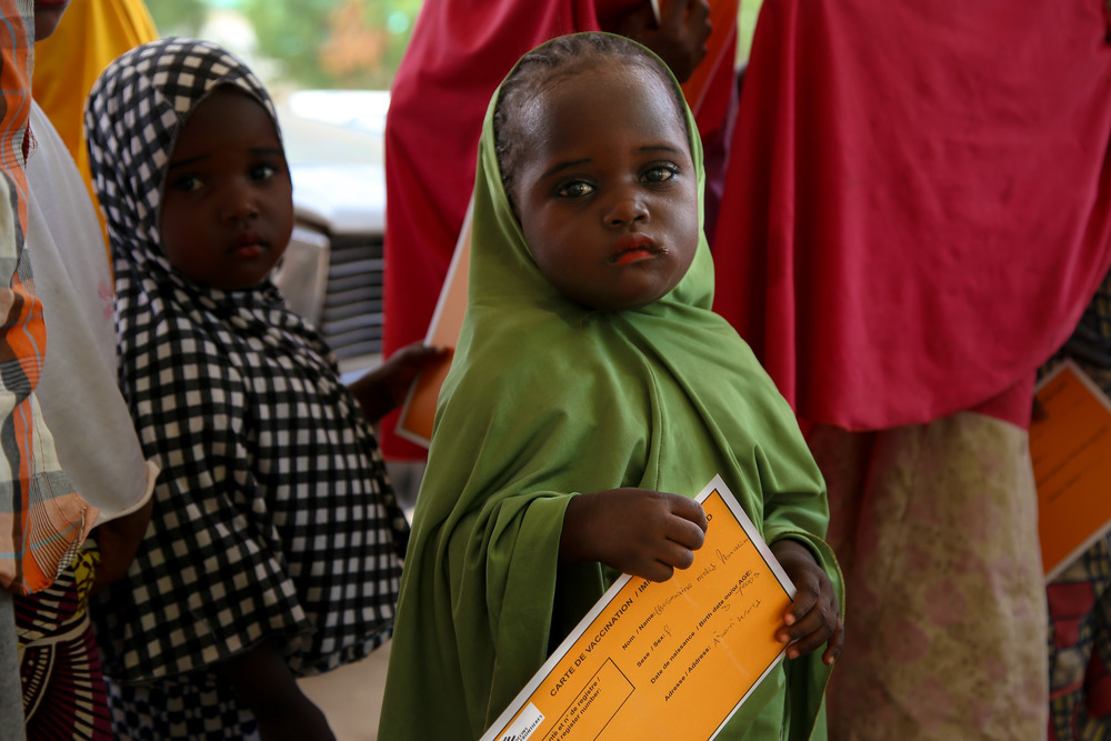 A small girl holds her MSF vaccination card in Damaturu town, in the north-eastern Nigerian state of Yobe.