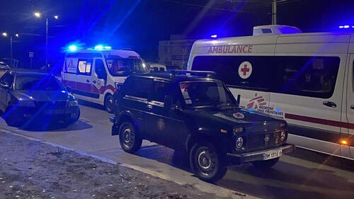 A jeep and ambulances on a dark street