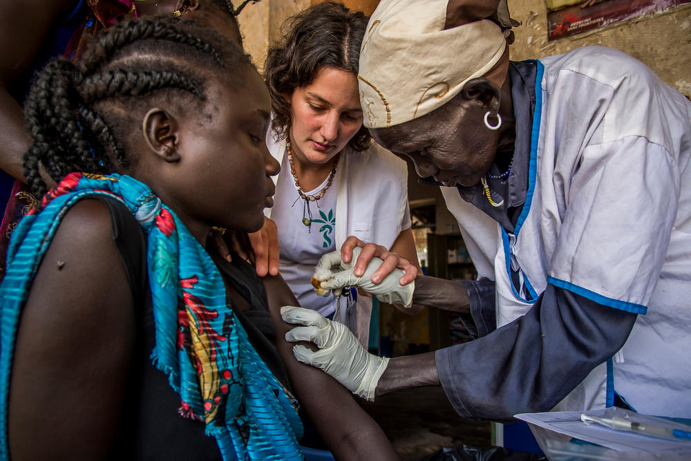 South Sudan: Midwife Camille shows a traditional birth attendant how to vaccinate a pregnant patient.