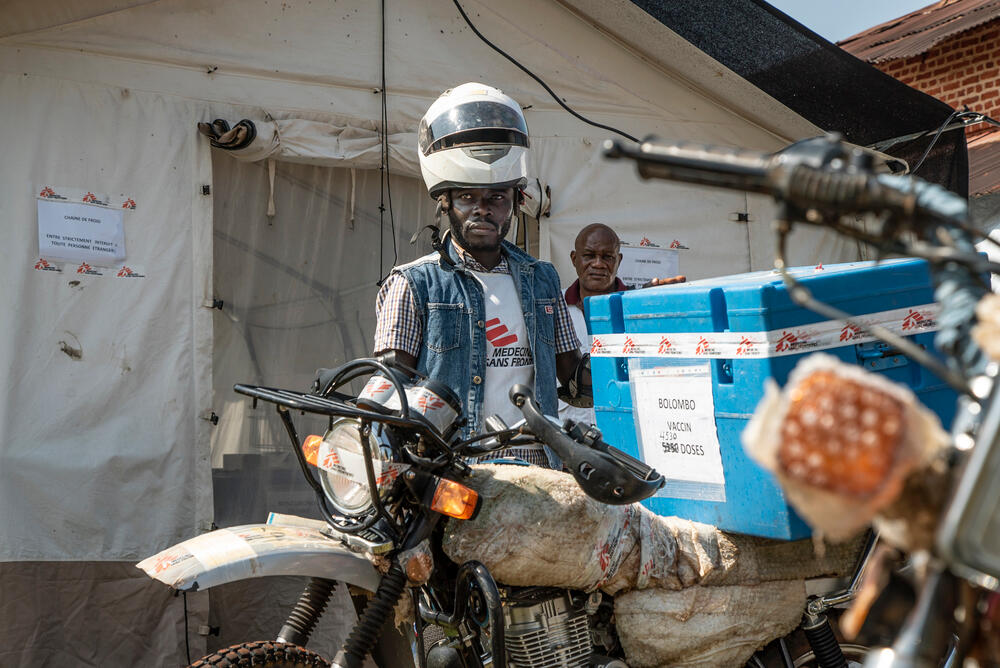 An MSF staff member with a motorbike loaded with measles vaccines. 