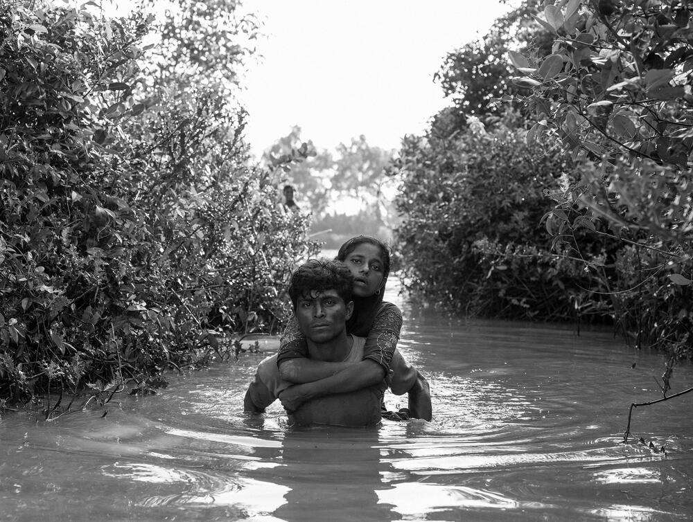 Rohingya refugees cross the Naf River from Myanmar into Bangladesh.