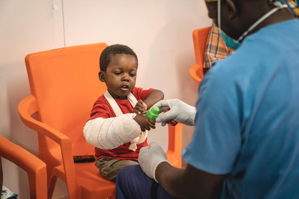Three-year-old Osmé, whose arm was crushed by rubble during the 14 August earthquake in his home in Jeremie, plays with an MSF physiotherapist in Tabarre hospital.