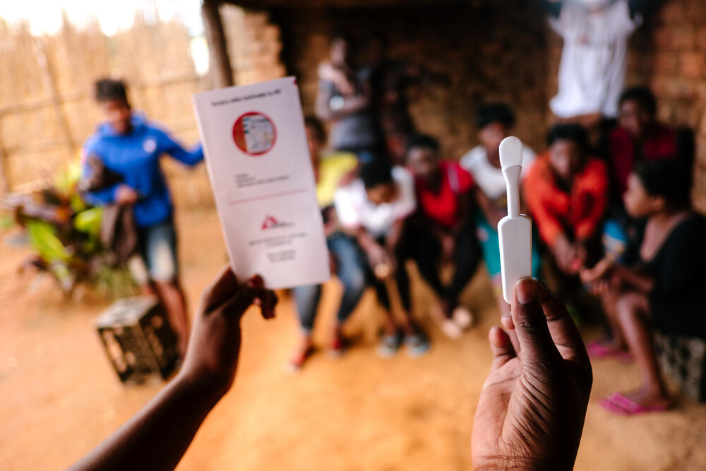 An MSF community health worker explains how to use an HIV self-test to sex workers at Dedza hotspot in Malawi