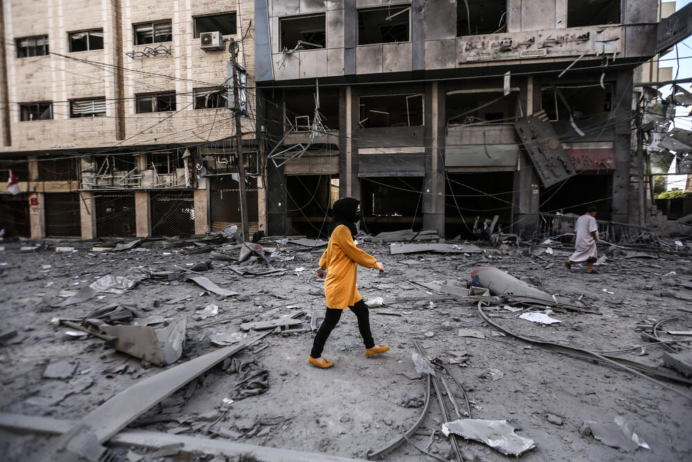 A Palestinian walks through debris in Gaza City following 11 days of intense aerial and ground bombardments