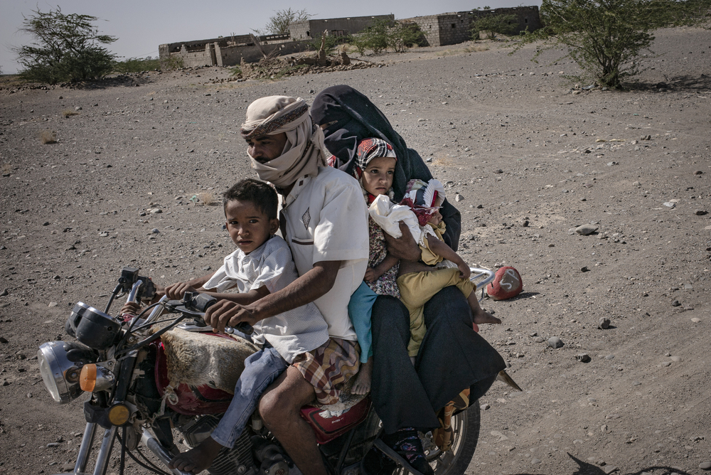 A family travelling together through the Mawza area of Yemen - the red stones indicated the presence of mines