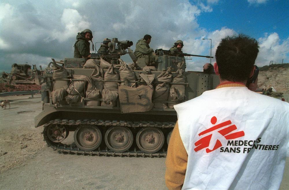 An MSF staff member waits at a check point in Palestine.
