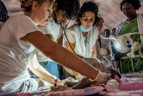 In the emergency room of the MSF hospital in Old Fangak, a large tent, almost all the MSF medical team is trying to resuscitate a newborn baby, just out of his mother's womb, taken to the hospital on an emergency basis in a speed boat.