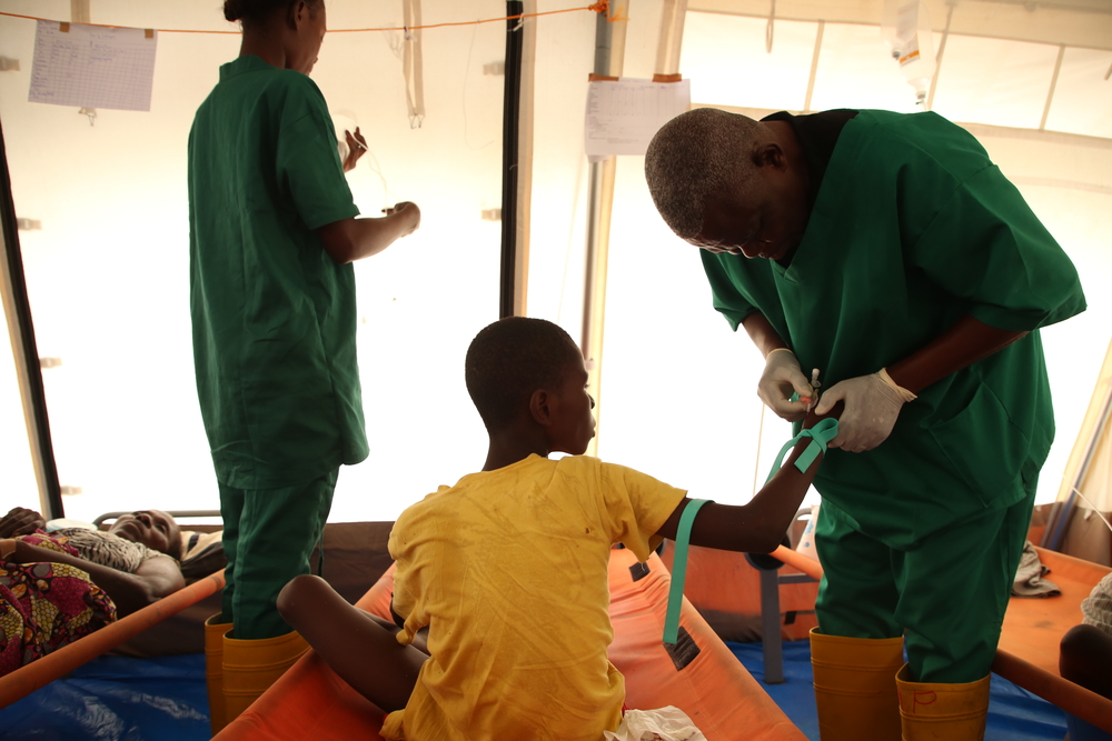 Un infirmier MSF administre une solution de réhydratation à un patient